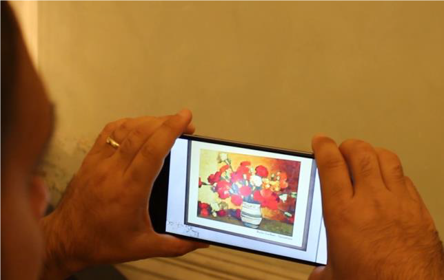 File:Figure 25- Mobile AR exposition. User looking at the painting “Still Nature” by Romanian painter S. Luchian..png